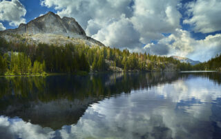 A beautiful photograph of a mountain lake overlooking Mammoth Mountain.