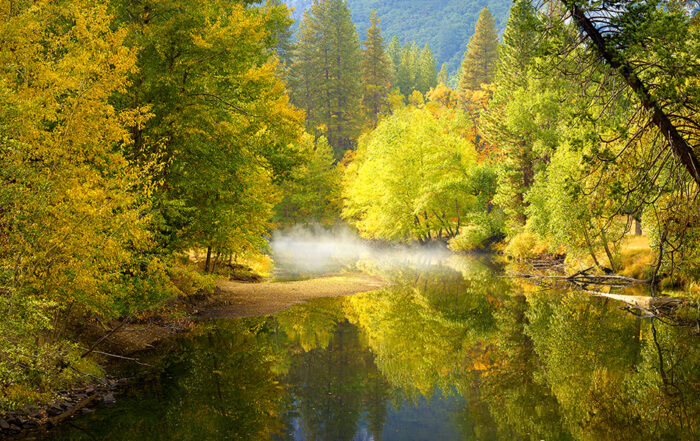 A calming scene of the Merced river in Yosemite national park during Autumn.