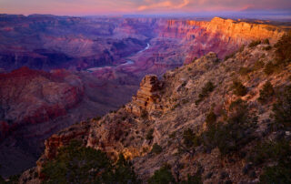 This fine art photograph captures the breathtaking majesty of the Grand Canyon at the Desert View lookout point during an ethereal sunset.